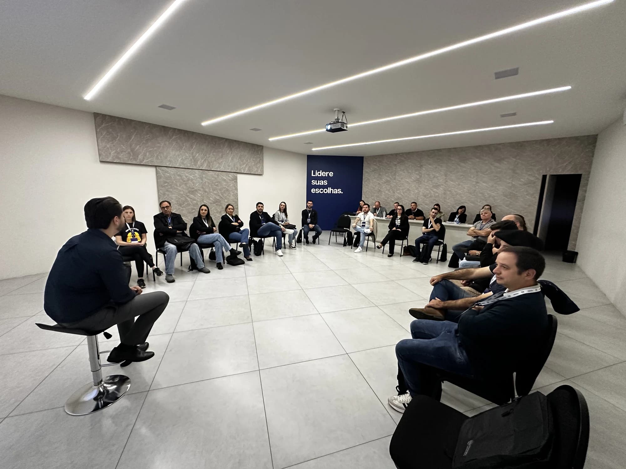 Turma reunida em uma grande roda com o facilitador durante o treinamento